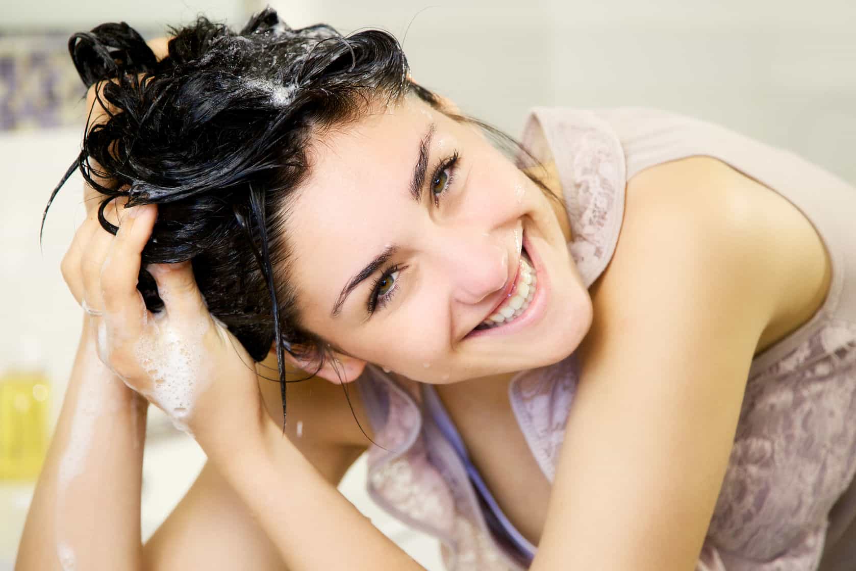 40657969 - cute girl in bathroom washing hair with shampoo