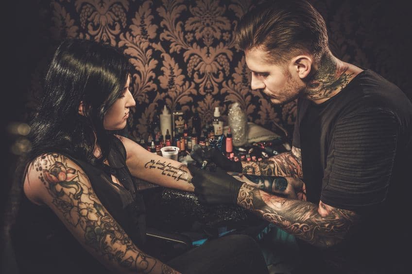 professional tattoo artist makes a tattoo